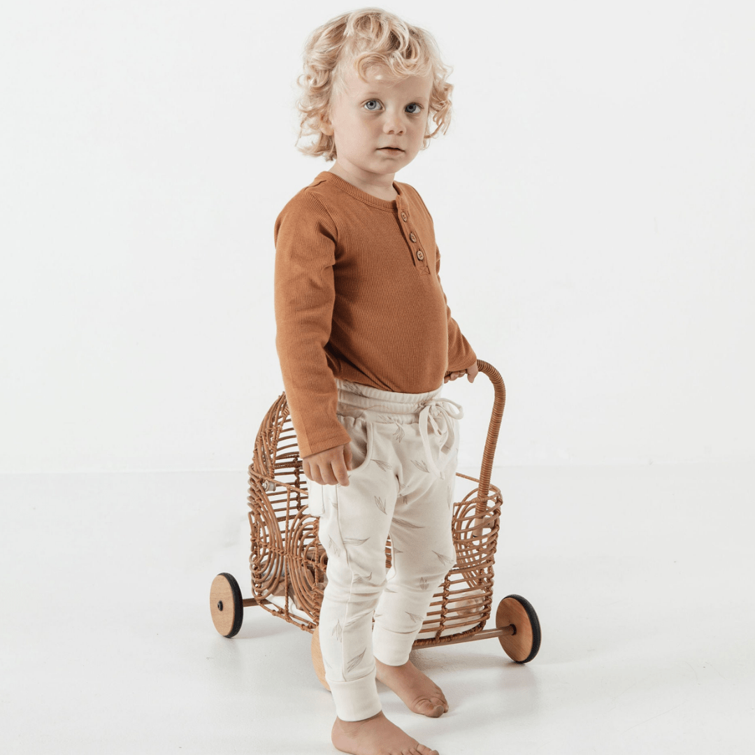 Side-View-of-Child-Wearing-Aster-and-Oak-Organic-Rib-Onesie-Pecan-Naked-Baby-Eco-Boutique