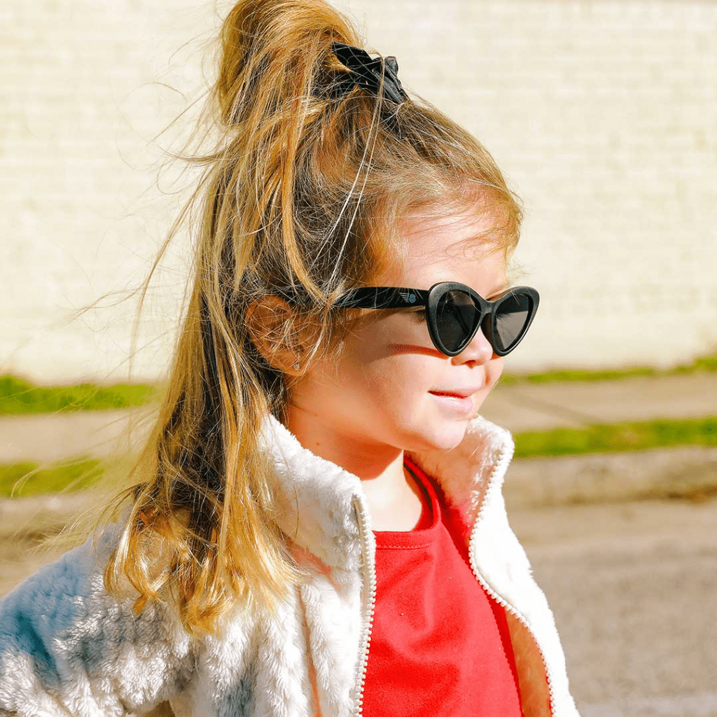 Side-View-of-Little-Girl-Wearing-Babiators-Cat-Eye-Baby-Kids-Sunglasses-Black-Naked-Baby-Eco-Boutique