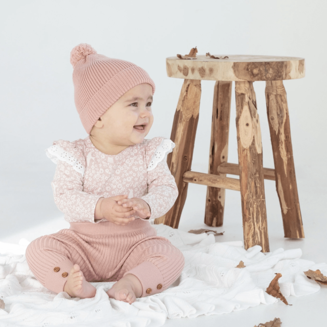 Smiling-Baby-Sitting-on-Blanket-Wearing-Aster-and-Oak-Organic-Knit-Leggings-Rose-Naked-Baby-Eco-Boutique