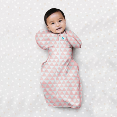 Smiling-Baby-Wearing-Close-up-of-Baby-in-Baby-in-Cot-Wearing-Love-to-Dream-Bamboo-Swaddle-Up-Lite-Coral-Naked-Baby-Eco-Boutique