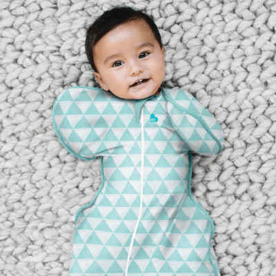 Smiling-Baby-in-Baby-in-Cot-Wearing-Love-to-Dream-Bamboo-Swaddle-Up-Lite-Ocean-Naked-Baby-Eco-Boutique