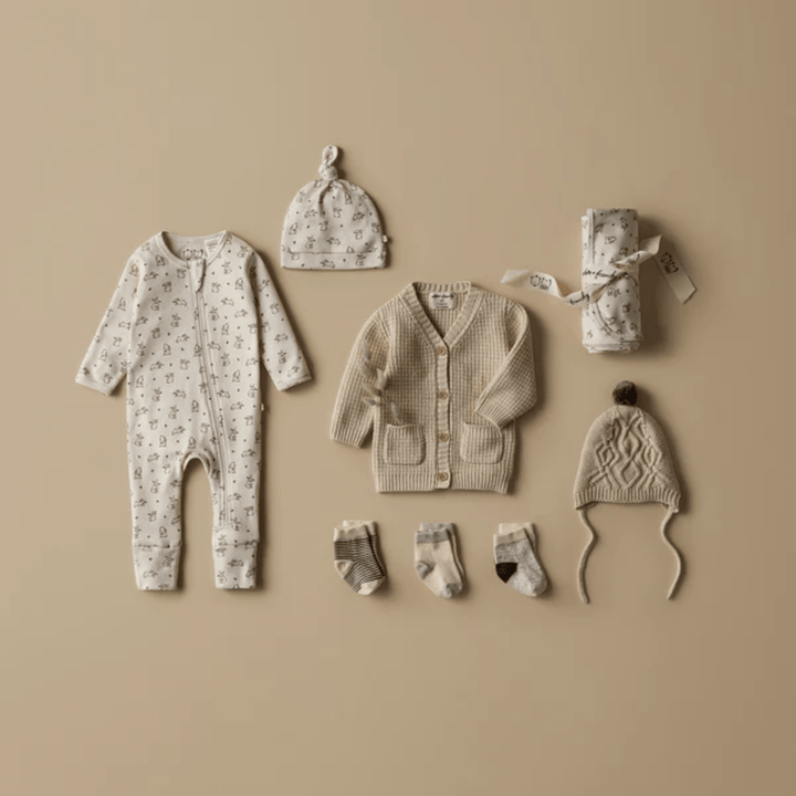 Styled-Flatlay-Wilson-And-Frenchy-Knitted-Cable-Bonnet-Oatmeal-Melange-Naked-Baby-Eco-Boutique