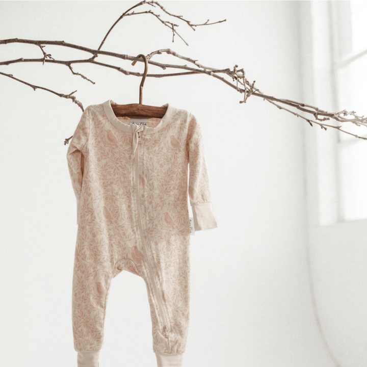 Styled-Hanging-Shot-of-Aster-and-Oak-Organic-Cotton-Long-Sleeved-Zip-Romper-Song-Bird-Naked-Baby-Eco-Boutique