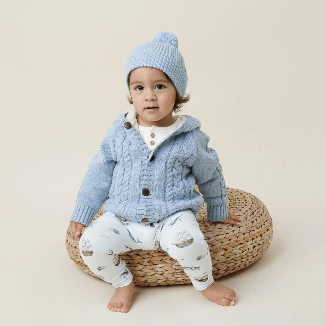 Toddler-Sitting-on-Stool-Wearing-Aster-and-Oak-Organic-Cotton-Pom-Pom-Beanie-Fog-Fleck-Naked-Baby-Eco-Boutique