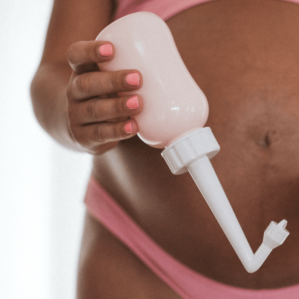 Woman-Holding-Viva-La-Vulva-Postpartum-Peri-Wash-Bottle-Naked-Baby-Eco-Boutique