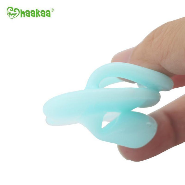 Blue Haakaa Silicone Orthodontic Dummy Being Flexed - Naked Baby Eco Boutique