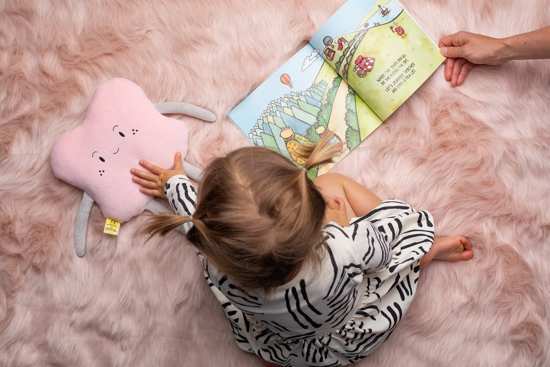 Little-Girl-Reading-with-The-Kiss-Co-Organic-Cotton-Big-Kiss-Stuffed-Toy-Naked-Baby-Eco-Boutique